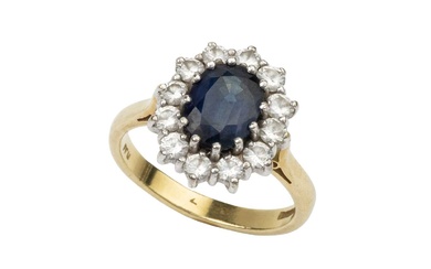 A sapphire and diamond cluster ring, the oval cut sapphire...