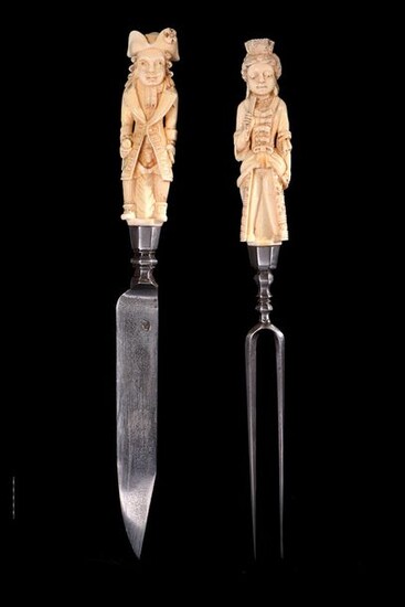 A serving fork and knife made of ivory and wrought iron, the handles carved in the hump represent two servants, a man and a woman richly dressed. Sliding sections of their clothing (one of which has disappeared) conceal the sexes of the two figures...