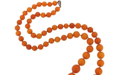 A single-row amber bead necklace, the round beads graduate from...