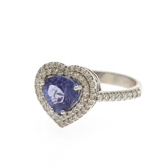 A tanzanite and diamond ring set with a heart-shaped tanzanite and numerous brilliant-cut diamonds, mounted in 14k. Size 54.5.