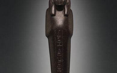 AN EGYPTIAN BROWN SERPENTINE USHABTI OF NEDJEM-IB, LATE 12TH/13TH DYNASTY, CIRCA 1800-1640 B.C.