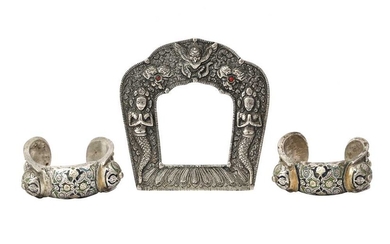 AN ENGRAVED SILVER FRAME AND A PAIR OF CHAMPLEVÉ ENAMELLED SILVER BRACELETS Thailand or Laos and Central Asia, 19th - 20th century