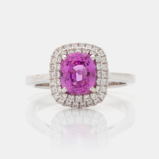 An 18K white gold ring set with a pink sapphire and round brilliant-cut diamonds
