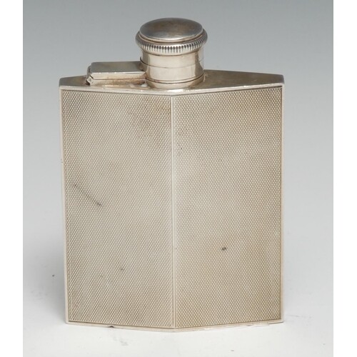 An Art Deco silver lozenge shaped hip flask, engine turned, ...