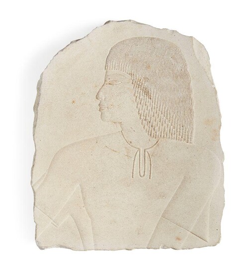 An Egyptian style limestone relief fragment with the profile bust of a male with well delineated eyes and finely layered wig and necklace, Not Ancient, 23.8cm x 20cm Provenance: Formerly in the private collection of Werner Forman (1915-2010)