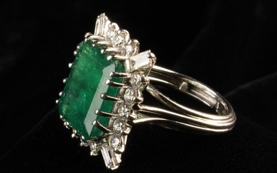 An Emerald and Diamond White Gold Ring. The central emerald cut stone surrounded by 1.7 carat of dia