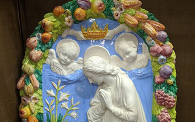 An Italian Della Robbia style ceramic arch of Madonna and Child