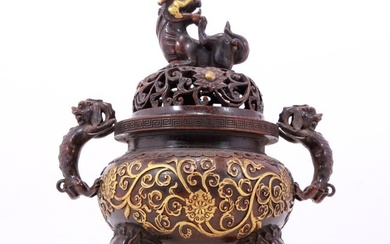An exquisite gilt bronze censer with double ears and three legs with lotus and auspicious animal