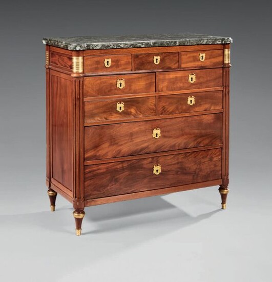 Chest of drawers in mahogany, mahogany veneer and chased and gilded bronze ornamentation, opening by nine drawers on four rows, the uprights formed by fluted half columns.
