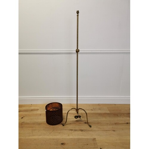 Early 20th C brass standard lamp with rope design and shade....