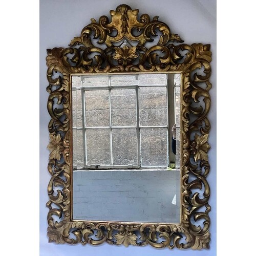 FLORENTINE WALL MIRROR, 19th century carved giltwood the bev...