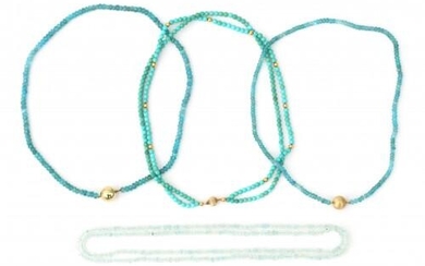 Four gem bead necklaces to a 14 karat gold clasp. Comprising a double strand turquoise necklace with gold spacers and clasp. An endless aquamarine necklace. And two apatite necklaces to gold clasps.