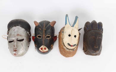 Four masks of carved and painted wood. Guro, Baule and Ogoni. Ivory Coast and Nigeria. H. 22-29 cm. (4)