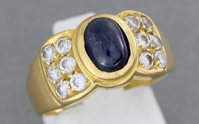 Gold ring set with a sapphire cabochon set with stones...