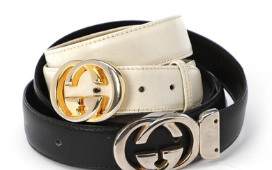 Gucci A set comprising two belts of respectively white leather with gold...