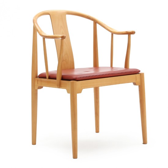 Hans J. Wegner: “China Chair”. Armchair of cherry wood. Seat upholstered with red leather.
