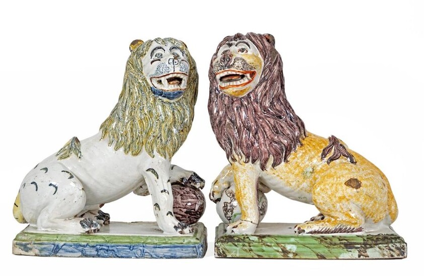 Pair of "Seated Lions, one paw on a globe" in polychrome earthenware