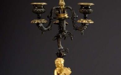 Richly decorated French bronze girandole with sculptural shaft "Reading Putto", 3 flames, bronze fire-gilt and burnished, 2nd half 19th c., h. 42cm