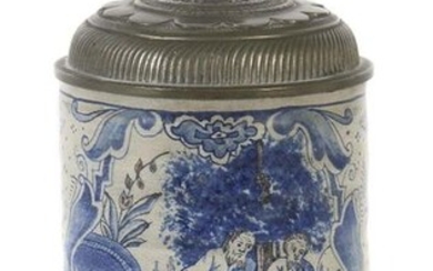 Roller jug ''Susanna in the bath'' South German or Switzerland, middle 18th century, grey body, white glazed, the wall in blue decorated with flowers and twigs, frontal cartouche with the biblical scene showing Susanna standing at a basin, the two...