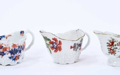 Three Lowestoft cream jugs, the first of Low Chelsea ewer form, painted in 'Tulip Painter' style, 10.2cm wide, the second of the same form a painted in underglaze blue and red with floral sprays pi...