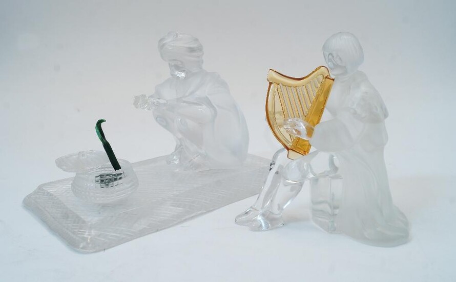 Two modern St Louis glass sculptures, comprising: the snake charmer and a harp player, the crouching snake charmer and basket signed Saint Louis, lacking pungi, the snake charmer - 17cm wide, 12cm high, the harp player - 12cm high (2)