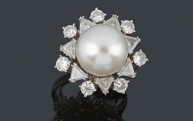 Ring with central Australian pearl with double border
