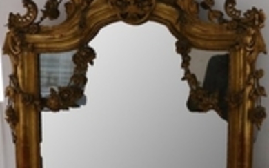 A large giltwood Rococo style mirror, with acanthus...