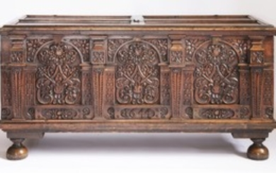 A walnut cassone, 1644, the hinged panelled top with a central escutcheon to a large and ornate ...