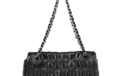CHANEL - a black perforated leather single flap handbag.