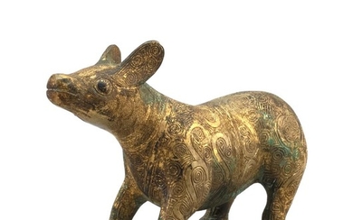 CHINESE GILT-BRONZE FIGURE OF A TAPIR With engraved scrolling decoration about the body. Height 4.5". Length 8".