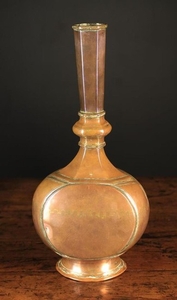 A 17th Century Mughal Copper Bottle or Wine Flask (Surahi) with traces of tinning. The tall, slightly flared hexagonal neck with knopped collar above a flattened bulbous body with central crenulated brass join, standing on a raised circular foot