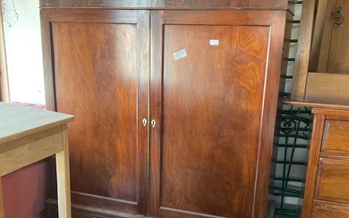 A 19th century mahogany press cupboard with moulded cornice above...