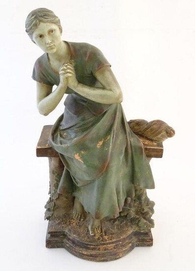 A 20thC French terracotta sculpture of a seated woman