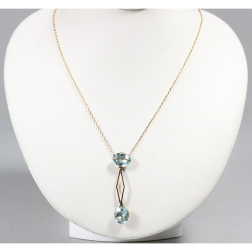 A 9ct gold aquamarine glass double drop pendant, chain, case