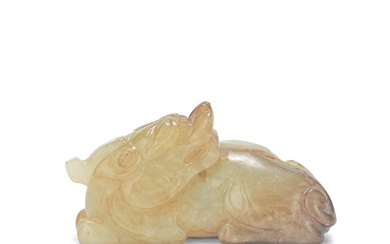 A CREAMY RUSSET JADE CARVING OF A RECUMBENT CHILONG Ming...