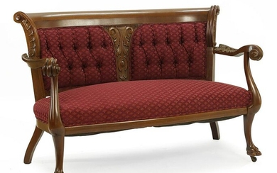 A Carved Mahogany Settee.