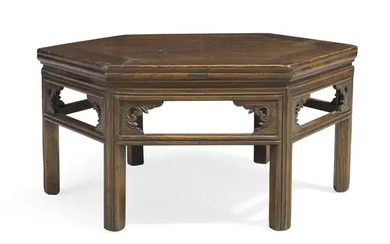 A Chinese elm hexagonal low table, Early 20th century With carved open...