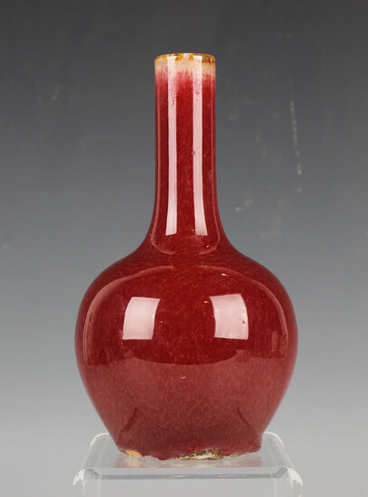 A Chinese sang-de-boeuf glazed bottle vase, 19th/20th century, covered in a streaky oxblood glaze, h