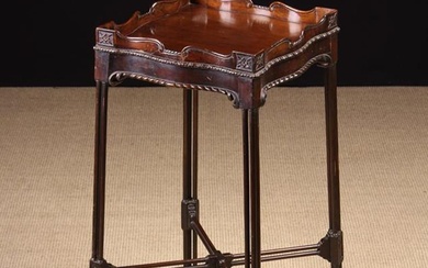 A Chippendale Style Mahogany Kettle Stand. The square serpentine top with carved gallery rail above