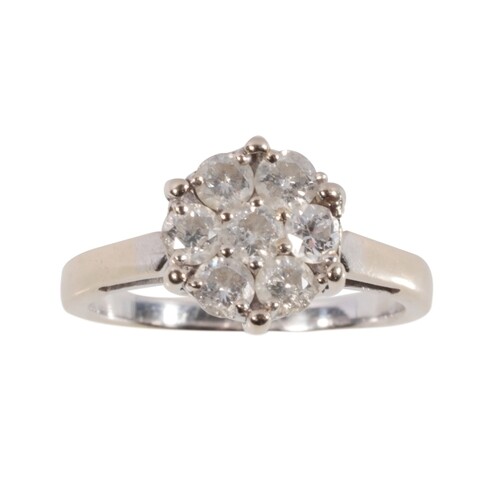 A DIAMOND CLUSTER RING the central brilliant-cut diamond, wi...