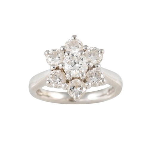 A DIAMOND SEVEN STONE CLUSTER RING, mounted in platinum. Es...