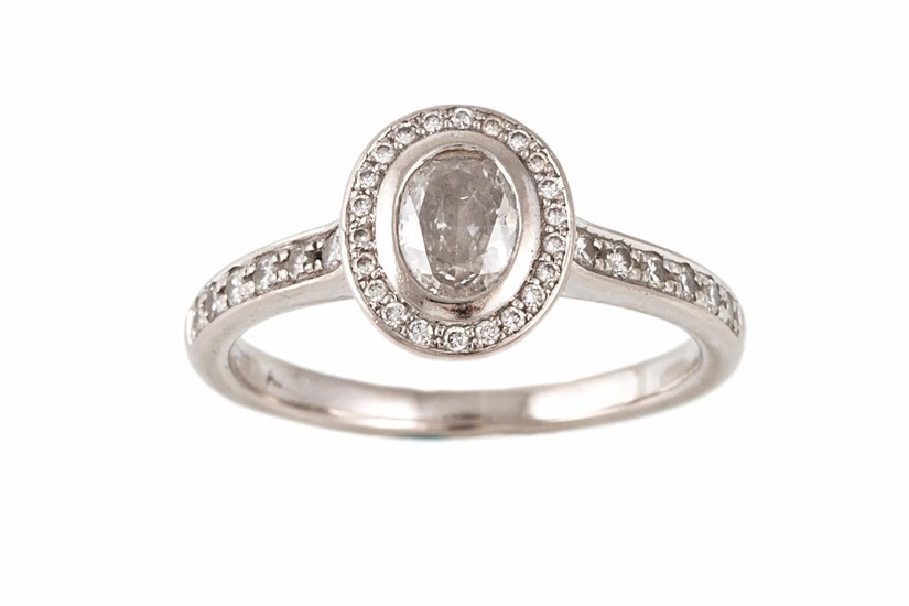 A DIAMOND SOLITAIRE RING, with oval cut centre diamond to a ...