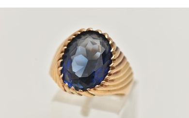 A GEM SET SIGNET RING, designed with an oval sapphire in a t...