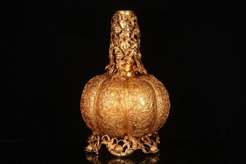 A GILT BRONZE CASTED MELON SHAPED CANDLE HOLDER