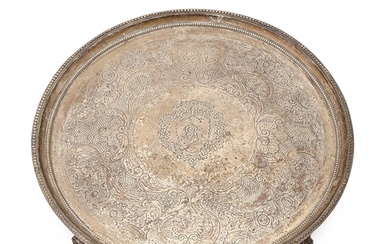 A George III silver salver, with beaded rim, on four fluted ...