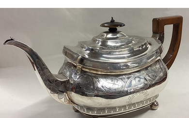 A George III silver teapot engraved with eagles and leaf dec...