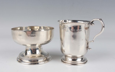 A George V silver circular footed bowl, the shallow bowl raised on a tapering flared stem and circul