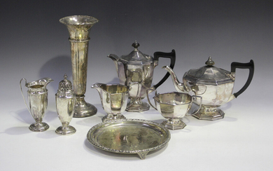 A George V silver sugar caster with domed pierced cover and matching cream jug, each with a faceted
