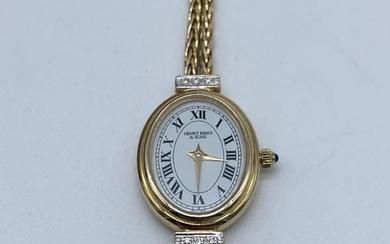 A Henry Burks and Son's Saphire Crystal 14kt Gold Ladies Diamond and Double Rope Band Time Piece