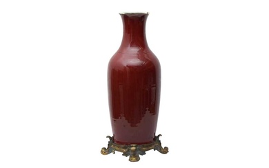 A LARGE CHINESE COPPER-RED GILT METAL-MOUNTED VASE 清十八世紀 紅釉瓶嵌鎏金銅飾